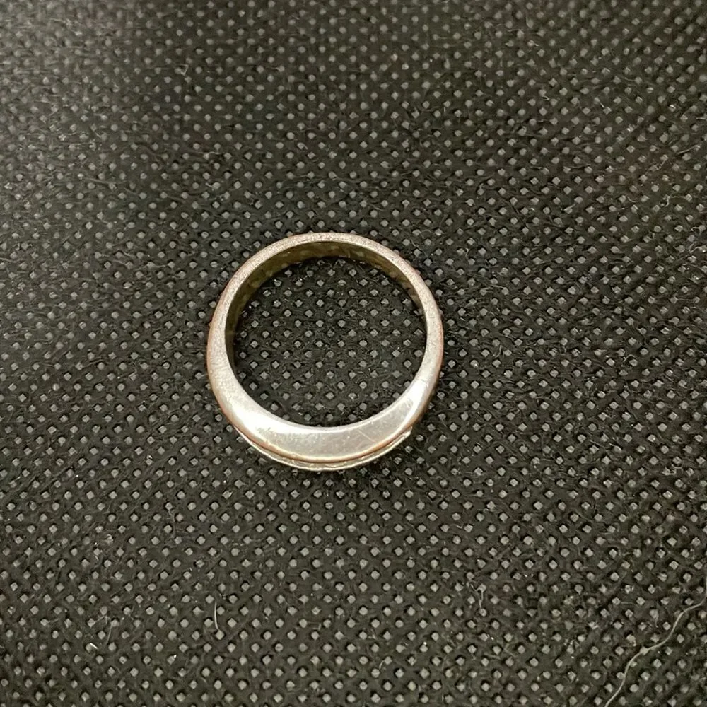 Metal ring with a row of white gems